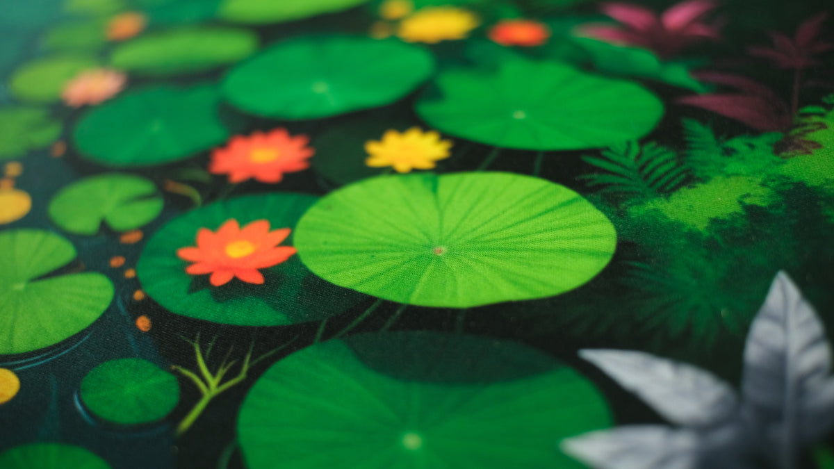 Close cloth of a Craftica deskmat — lotus pads and ink on woven fabric